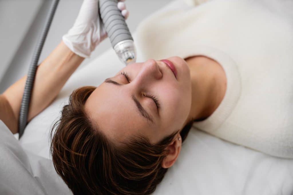microneedling procedure being done to a patient by an aesthetic professional