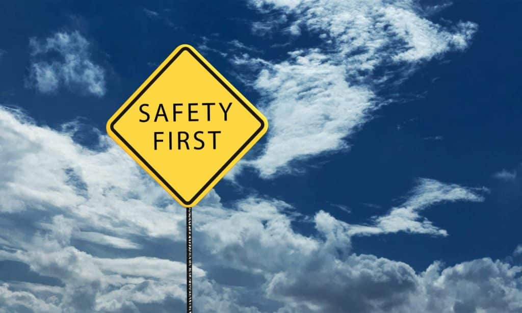 words safety first on a yellow road sign with the blue skies as background