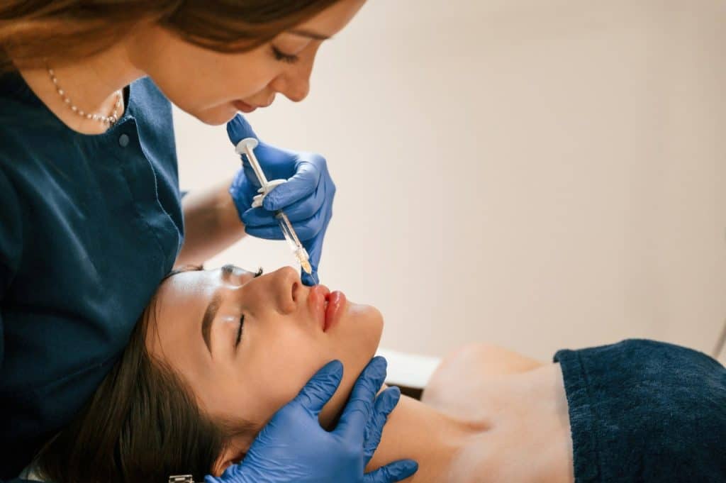 aesthetic practitioner injecting a patient's lips