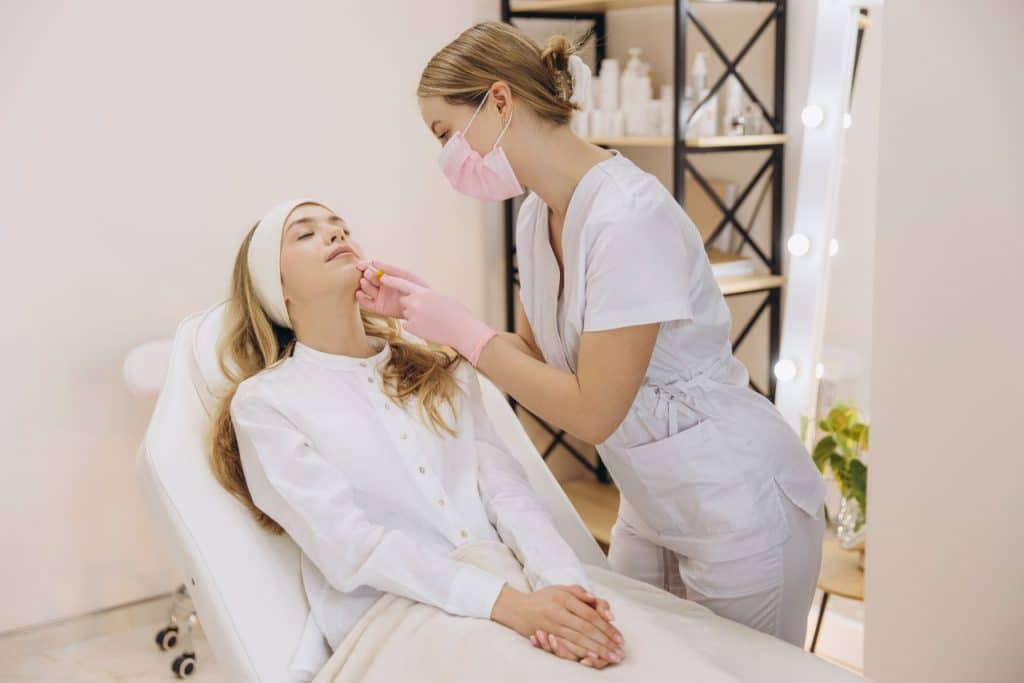 aesthetic practitioner injecting botox in patient's lips