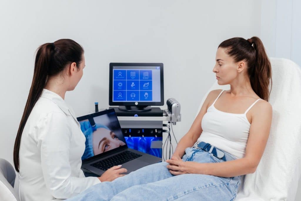 aesthetics practitioner talking to a patient