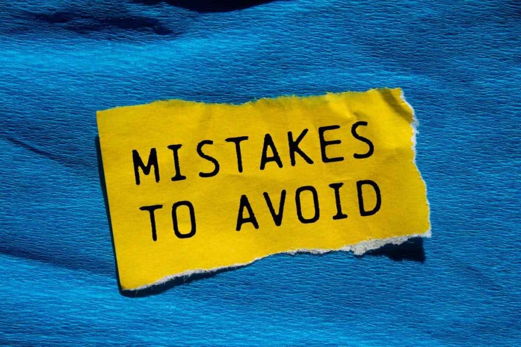 Mistakes to avoid message written on ripped torn yellow paper
