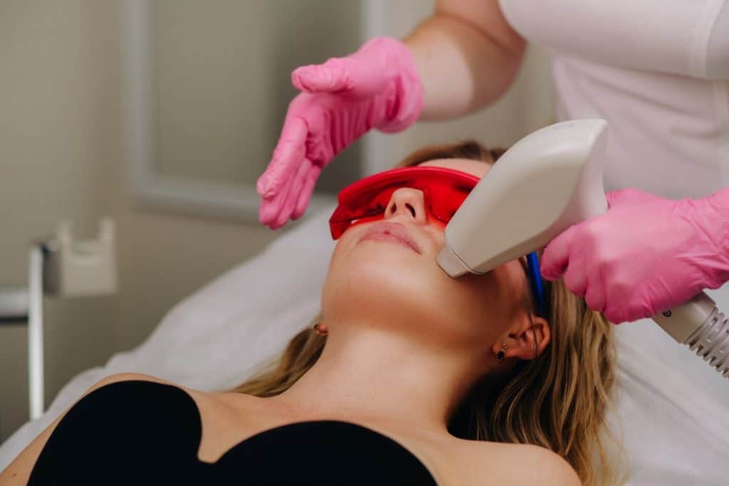 woman getting laser treatment on her skin in an aesthetic clinic