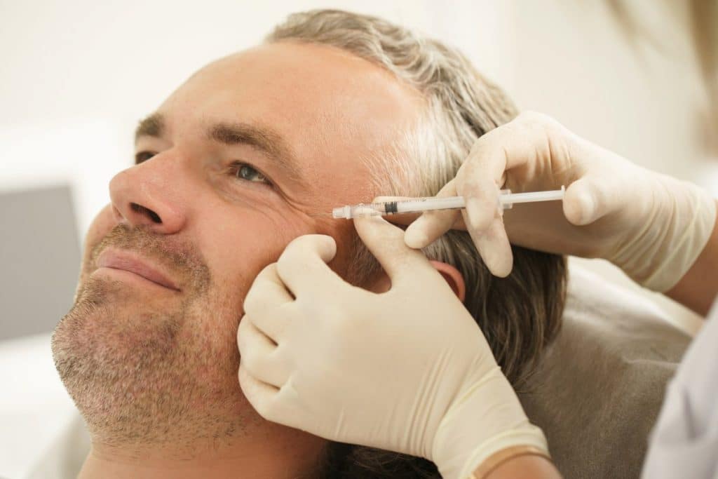 Aesthetics practitioner performing jawline filler treatment at Matrix Academy