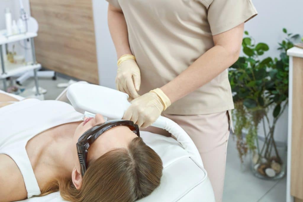 Female receiving laser hair removal treatment