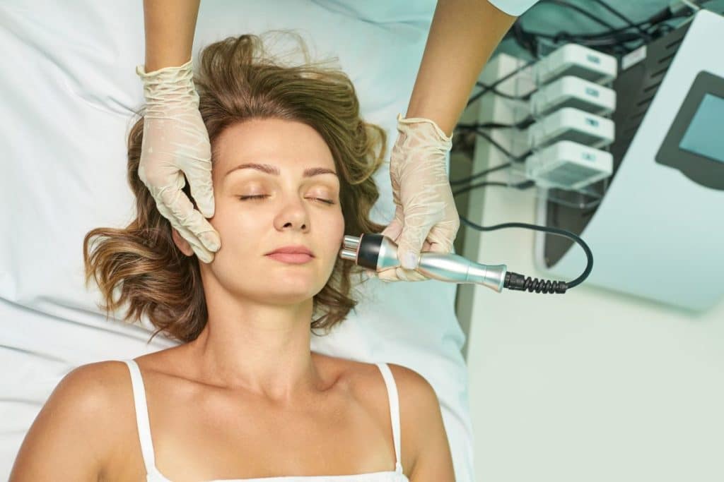 female receiving non-invasive facial treatment