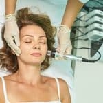 female receiving non-invasive facial treatment