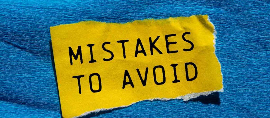 Mistakes to avoid message written on ripped torn yellow paper